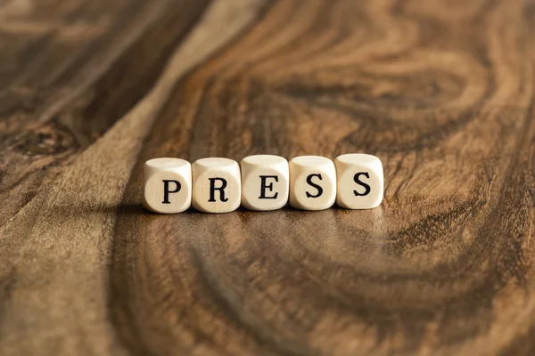 Word Press op houten kubussen — Stockfoto