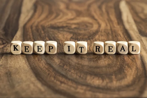 Word KEEP IT REAL on wooden cubes — Stock Photo, Image