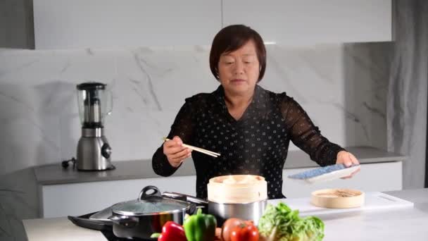 Asian Woman Moving Dumplings Bamboo Steamer Plate Using Chopsticks Kitchen — Stock Video