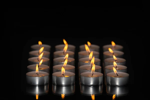 Select focus of an artistic arrangement of lit tea light candles. Relaxation and abstract concept. — Stock Photo, Image