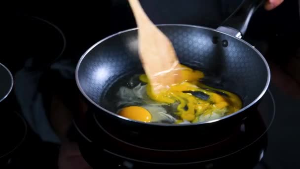 Close Three Eggs Being Thrown Frying Pan Electric Cooktop Stirred — 图库视频影像