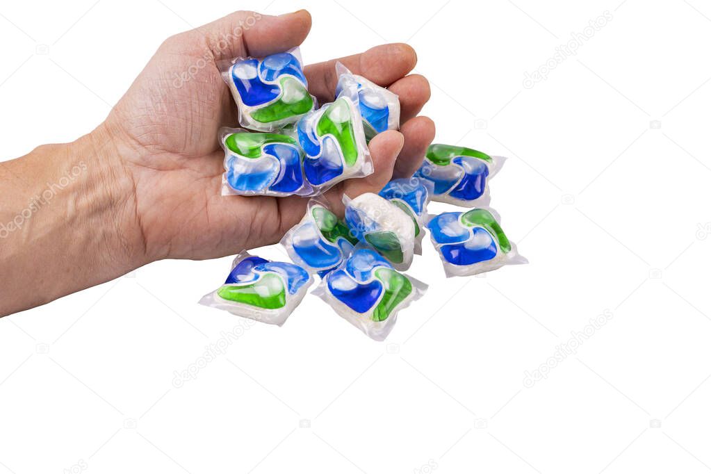 Close up view of colorful dishwasher capsules in male hand on white background. 