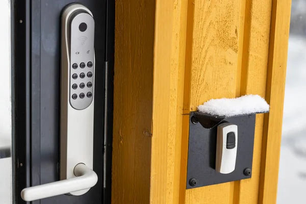 Close up view of an electric combination lock on a black door. Interior design. Beautiful backgrounds.