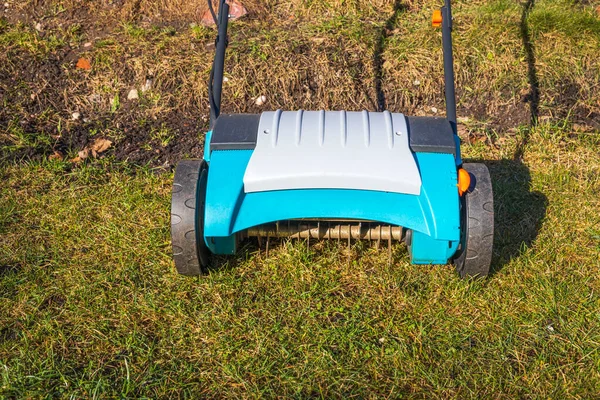 View of electric lawn aerator on green grass isolated. Garden machines concept. Sweden.
