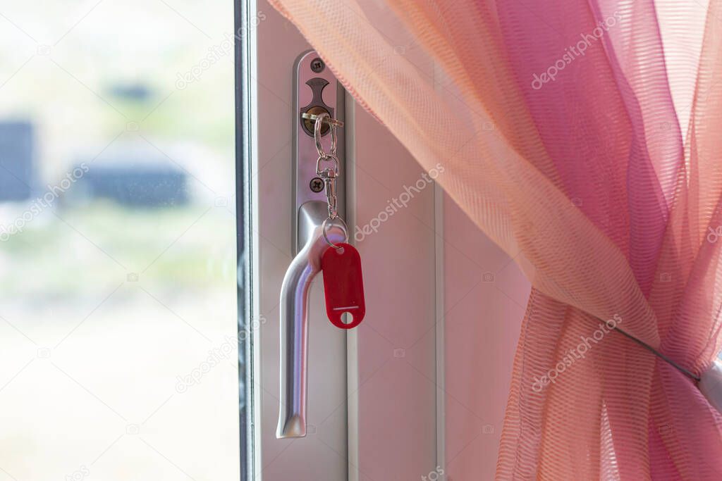 Close up view of key in keyhole of steel door handle. Sweden.