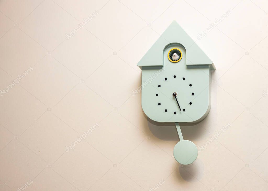Close up view of grey wall cuckoo clock on  background. Sweden.