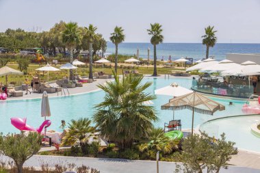 Beautiful view of swimming pool and pool bar of Portes Lithos Luxury Resort. Greece. Nea Potidaea. 07.18.2021.