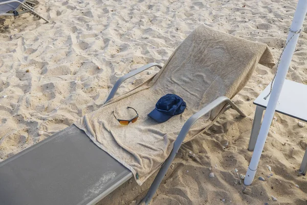 Close up view of personal belongings left on sunbeds. Greece.