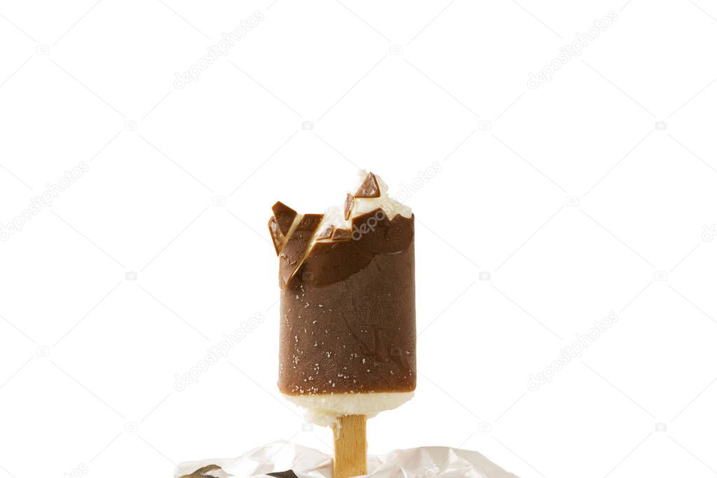 Close up view of bitten off ice cream in chocolate glaze on white background.