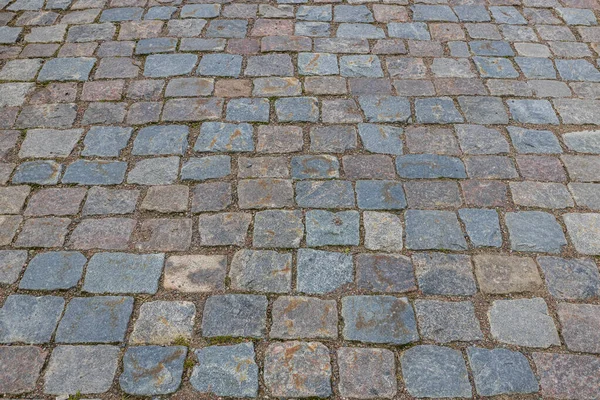 Old cobblestone pavement stone walkway background. Cobblestone pavement texture. Sweden