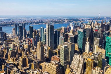 Magnificent panoramic view of Manhattan skyline and Hudson River with dense skyscrapers against blue sky. New York. USA.