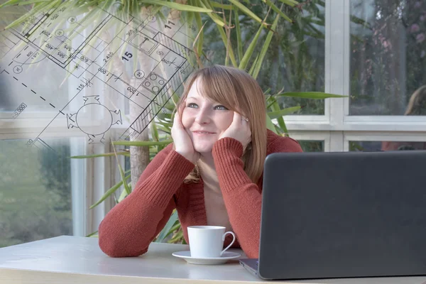 Young woman is dreamily looking at blueprint — Stock Photo, Image