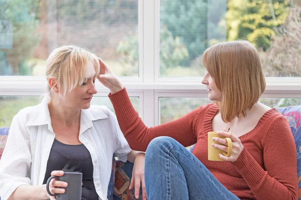 Young woman is touching the head of the other woman — Stock Photo, Image