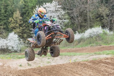 Closeup of quad rider in high jump
