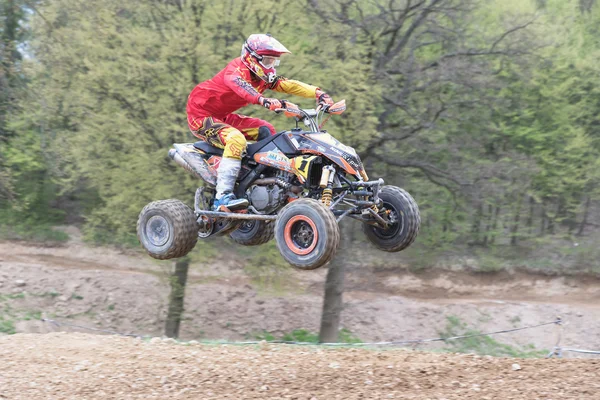 Quad racer in red is jumping — ストック写真