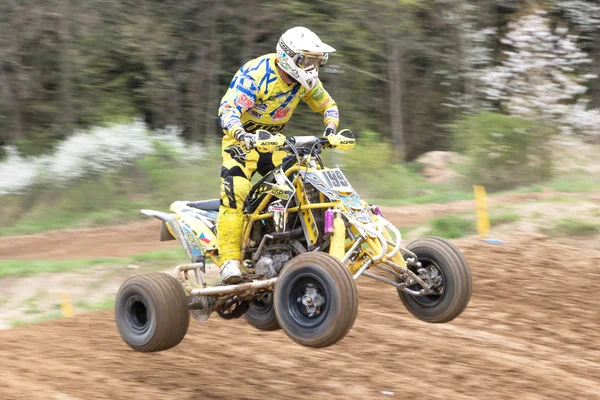 Closeup dynamic shot of quad rider in yellow — Zdjęcie stockowe