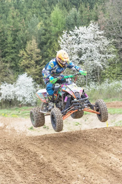 Quad rider is jumping in muddy terrain . Vertically. — Stock Photo, Image