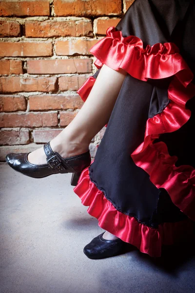 Legs of woman dressed in costume of Flamenco dancer Stock Image