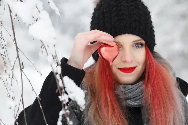 冬季雪天 一个红头发美女用红心捂住一只眼睛的前视图画像 — 图库照片