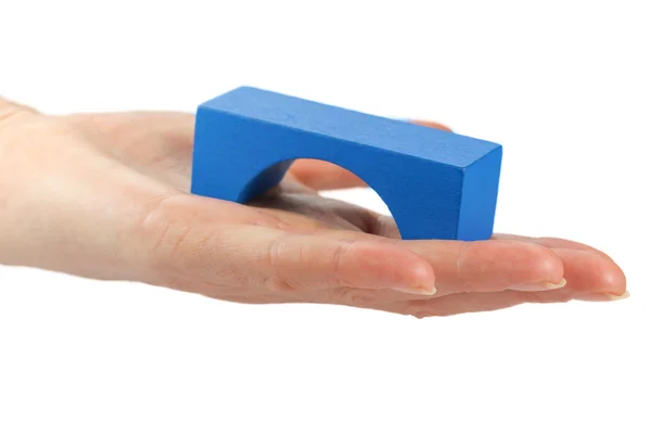 Holding blue wooden bridge toy — Stock Photo, Image