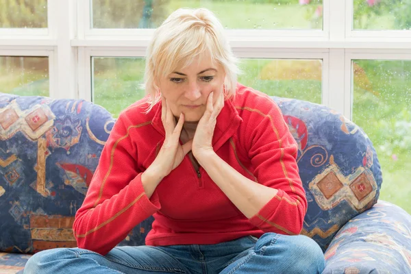 Frustrated blonde middle-aged woman — Stock Photo, Image