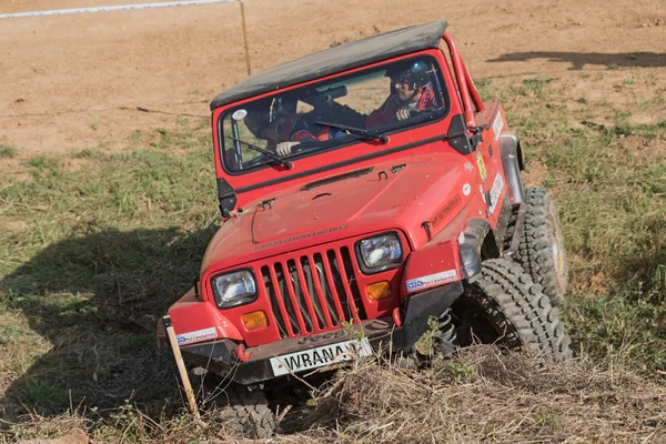 Red off road car is exceeding the difficult terrain — 图库照片