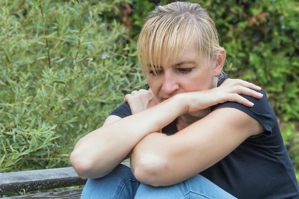 Frustrated middle aged woman in black shirt