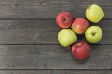 Ahşap masa üzerinde kırmızı ve yeşil elma