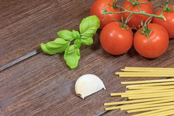 Tomate, dientes de ajo, pasta y hojas de albahaca —  Fotos de Stock