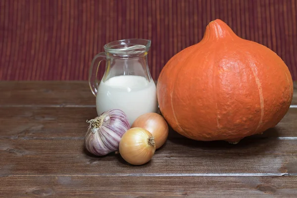 Ingredients to cooking  creamy pumpkin soup on the wooden table — Stock Photo, Image