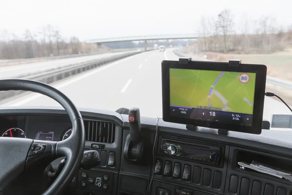 Tablet with navigation in truck cabin during drive — Stock Photo, Image