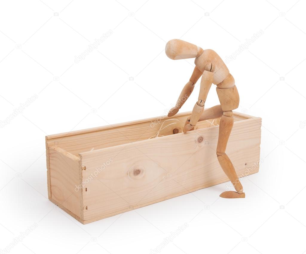 Wood figure mannequin stepping in a wooden box