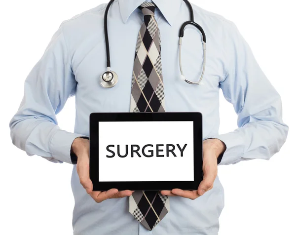 Γιατρός κρατώντας δισκίο - χειρουργική επέμβαση — Φωτογραφία Αρχείου