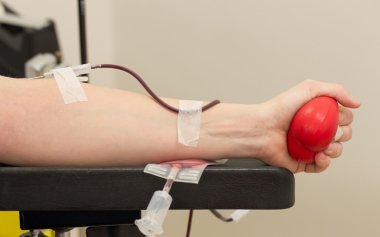 Donor in an armchair donates blood,, close-up clipart