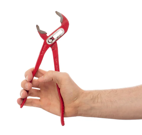 Hand of male plumber with a red wrench — Stock Photo, Image