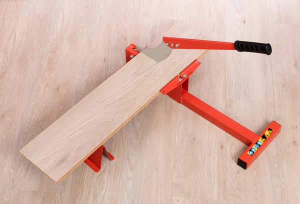 Red tool for cutting laminate — Stock Photo, Image