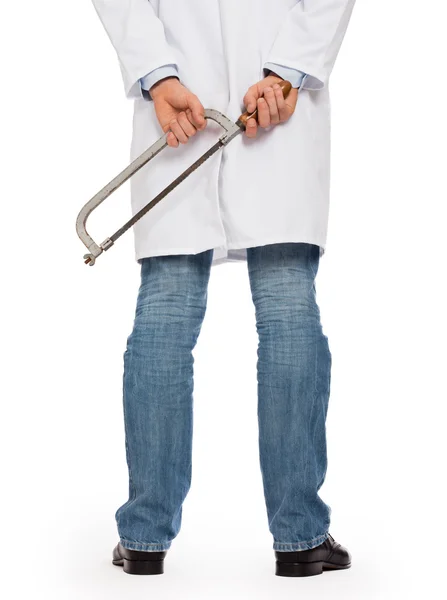 Crazy doctor is holding a big saw in his hands — Stock Photo, Image