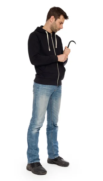 Crime concept. Criminal in hood with crowbar in hand — Stock Photo, Image