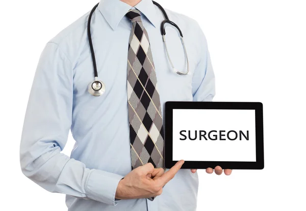 Lekarz trzymając tabletkę - chirurg — Zdjęcie stockowe