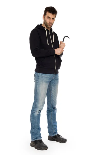 Crime concept. Criminal in hood with crowbar in hand — Stock Photo, Image