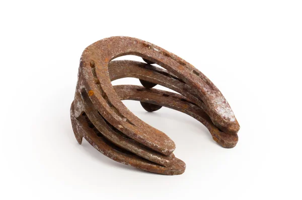 Stack of old rusty horseshoes — Stock Photo, Image