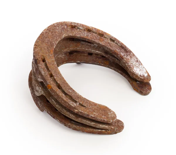 Stack of old rusty horseshoes — Stock Photo, Image