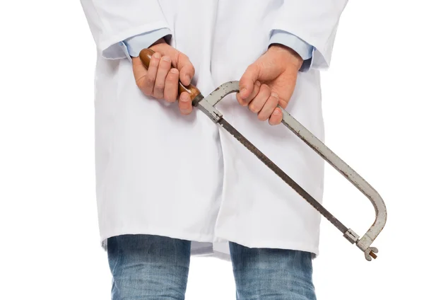 Crazy doctor is holding a big saw in his hands — Stock Photo, Image