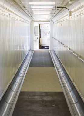Jetway, walking towards the plane, selective focus clipart