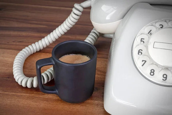 Old office - Have a break, a small espresso cup with an old telephone, selective focus