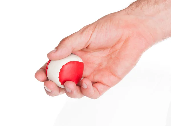 Mano maschile con una palla rossa e bianca — Foto Stock