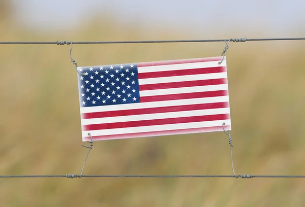 Borderhekje - oude plastic bord met een vlag — Stockfoto