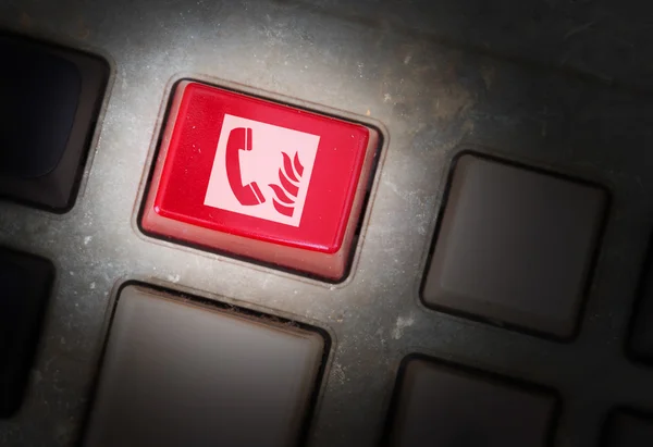 Red button on a dirty old panel — Stock Photo, Image