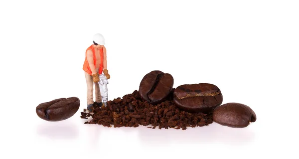 Miniature worker working on a coffee bean — Stock Photo, Image