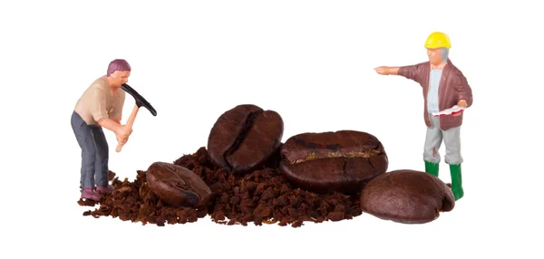 Miniature worker working on a coffee bean — Stock Photo, Image